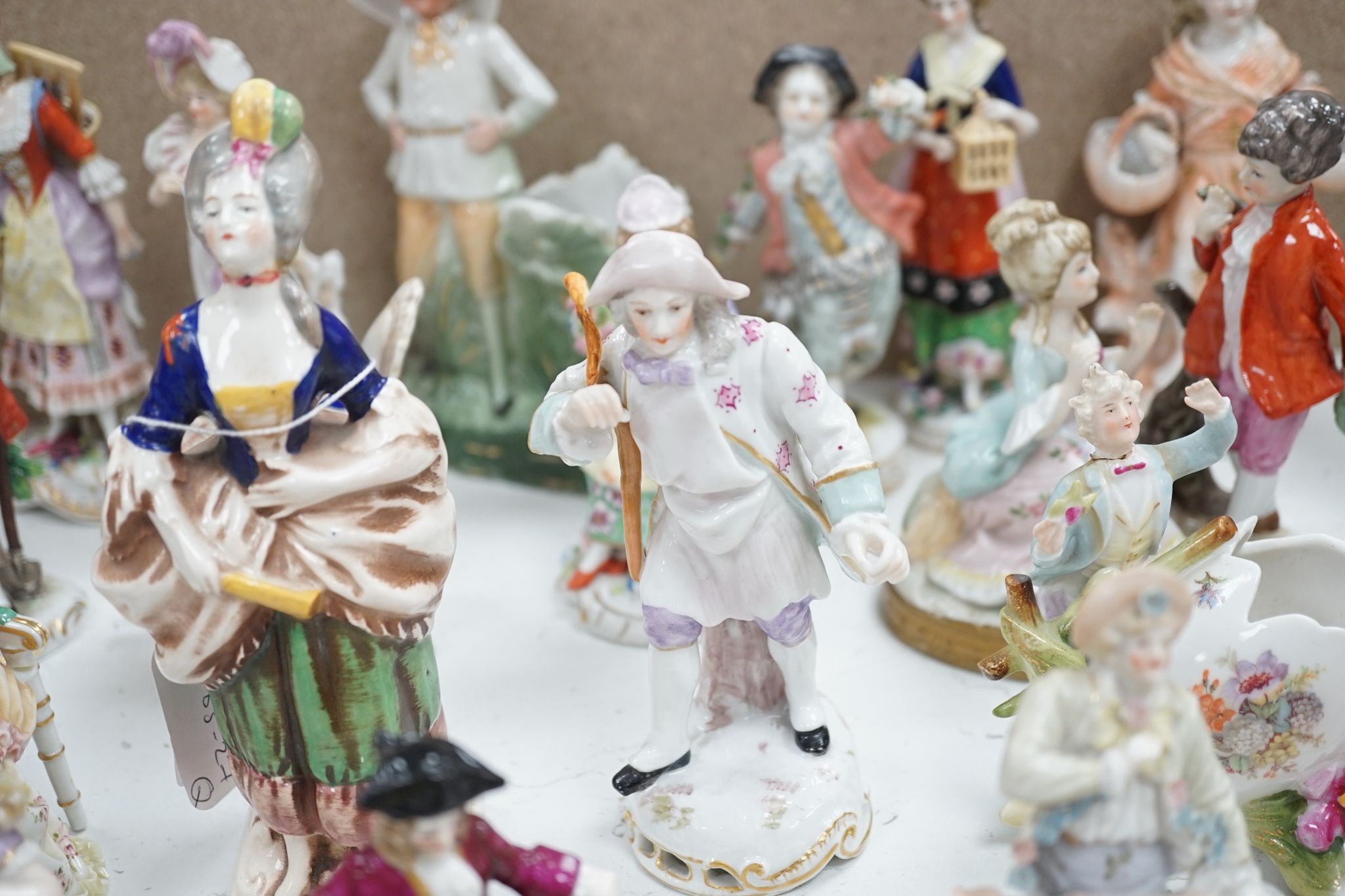 A large collection of small to medium German, French and English porcelain figurines and groups, tallest 18cm